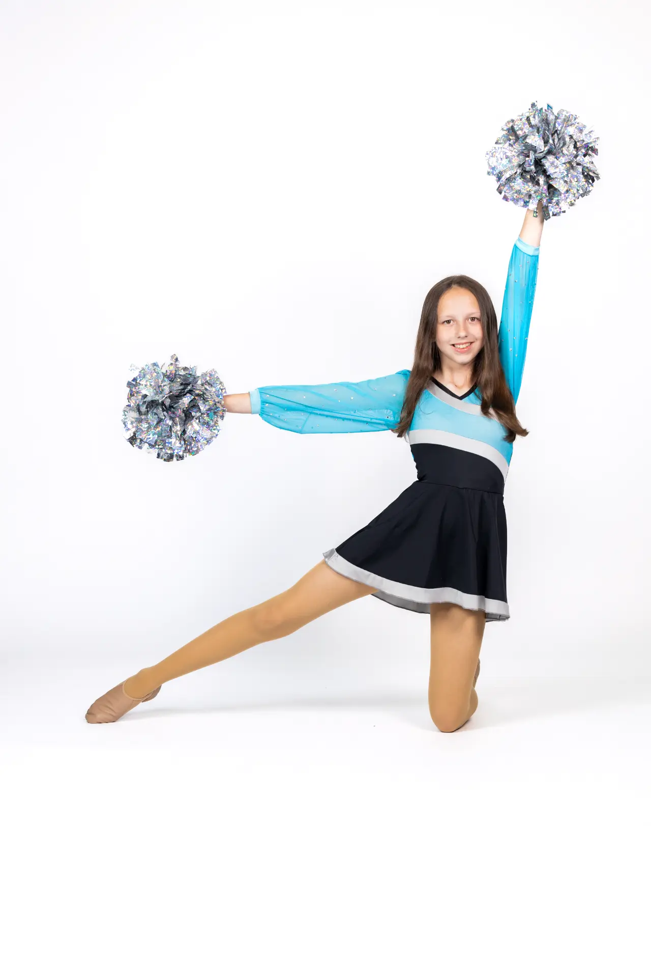 Dancer kneeling with silver pom-poms