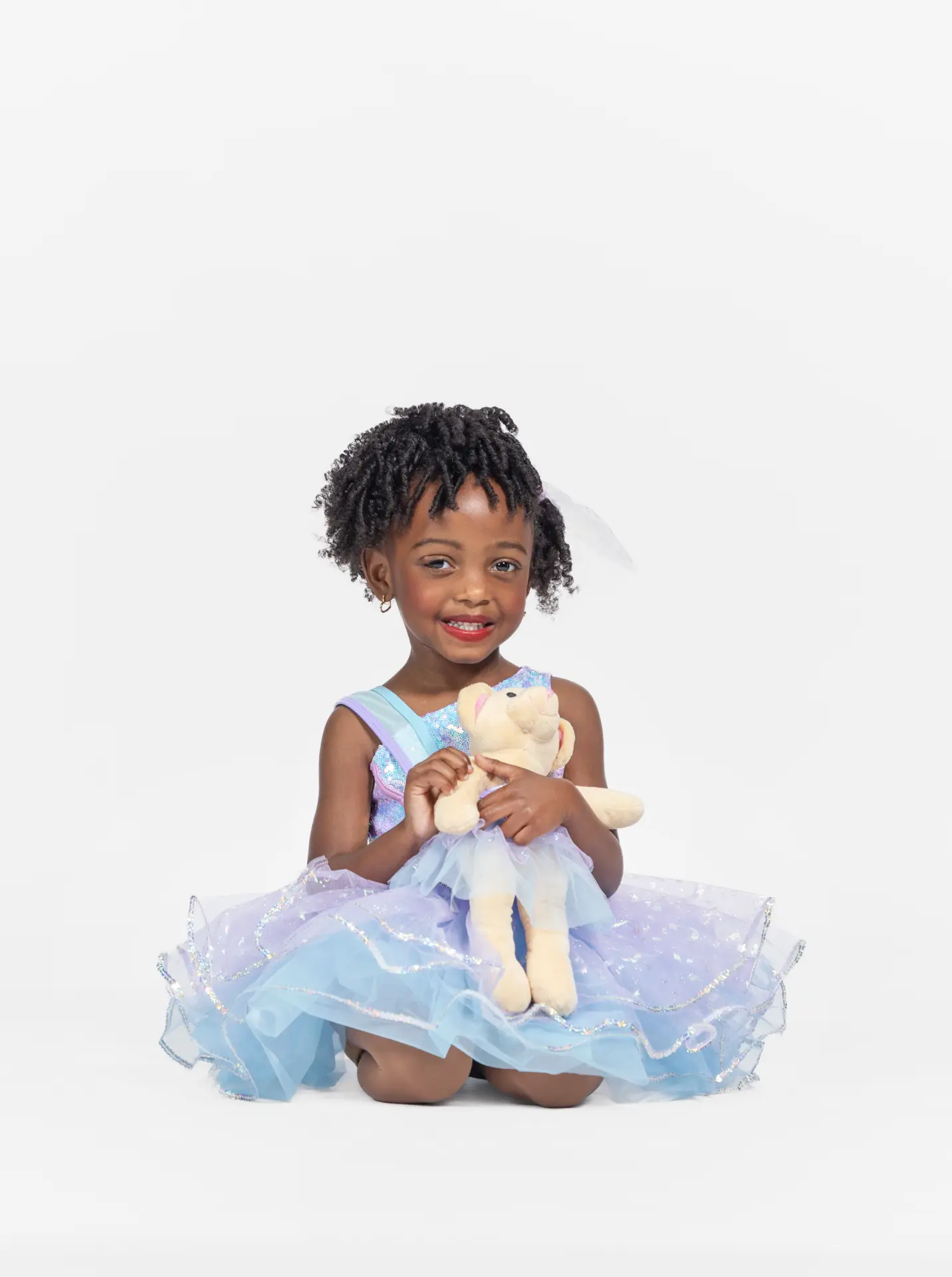 Young ballerina holding a teddy bear